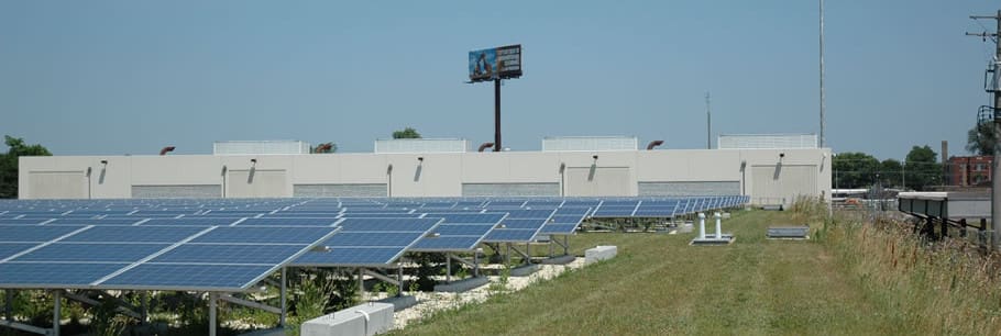 A field with many solar panels on the top of it.